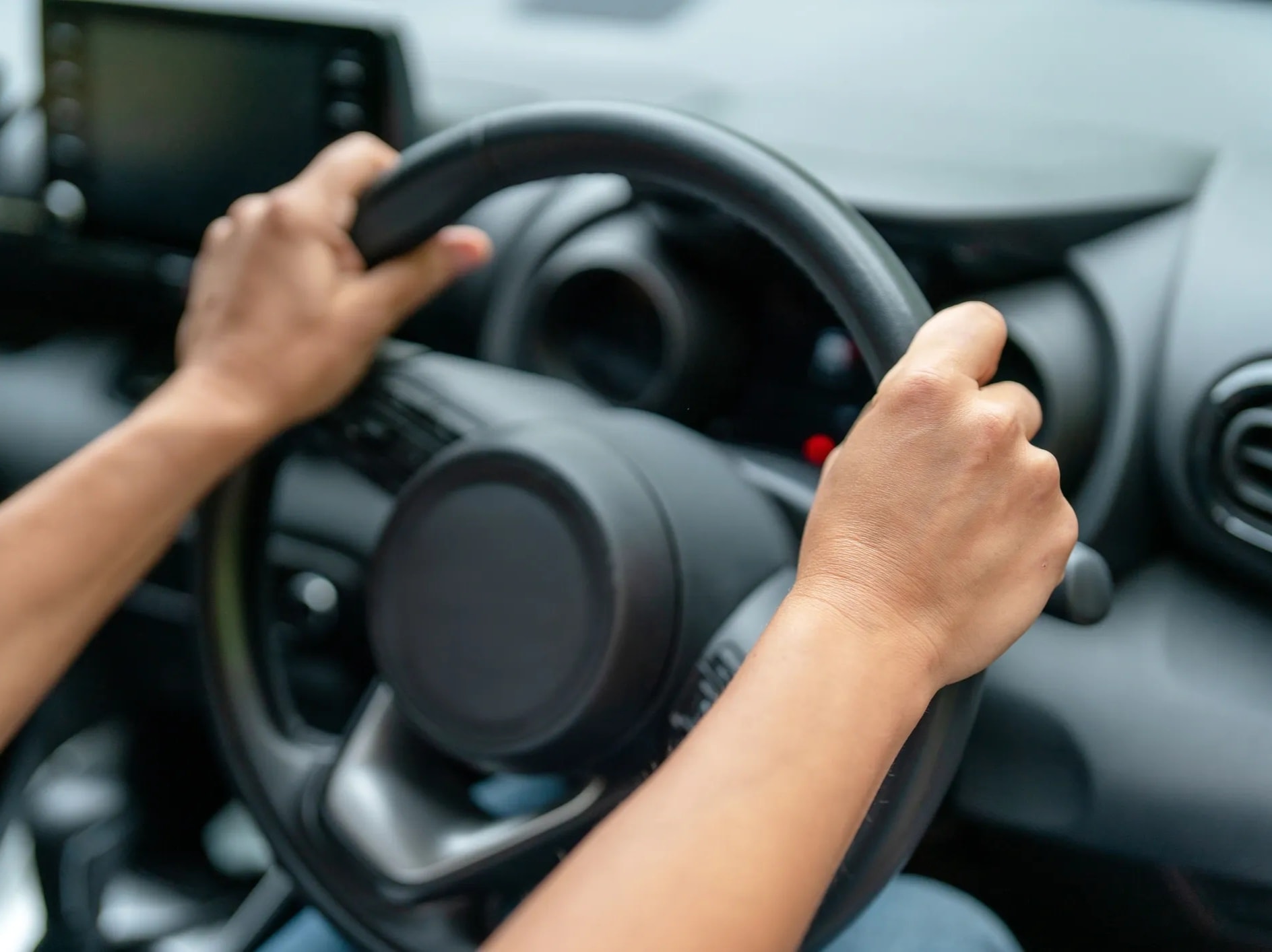 Person driving car with OT instructor in passenger seat