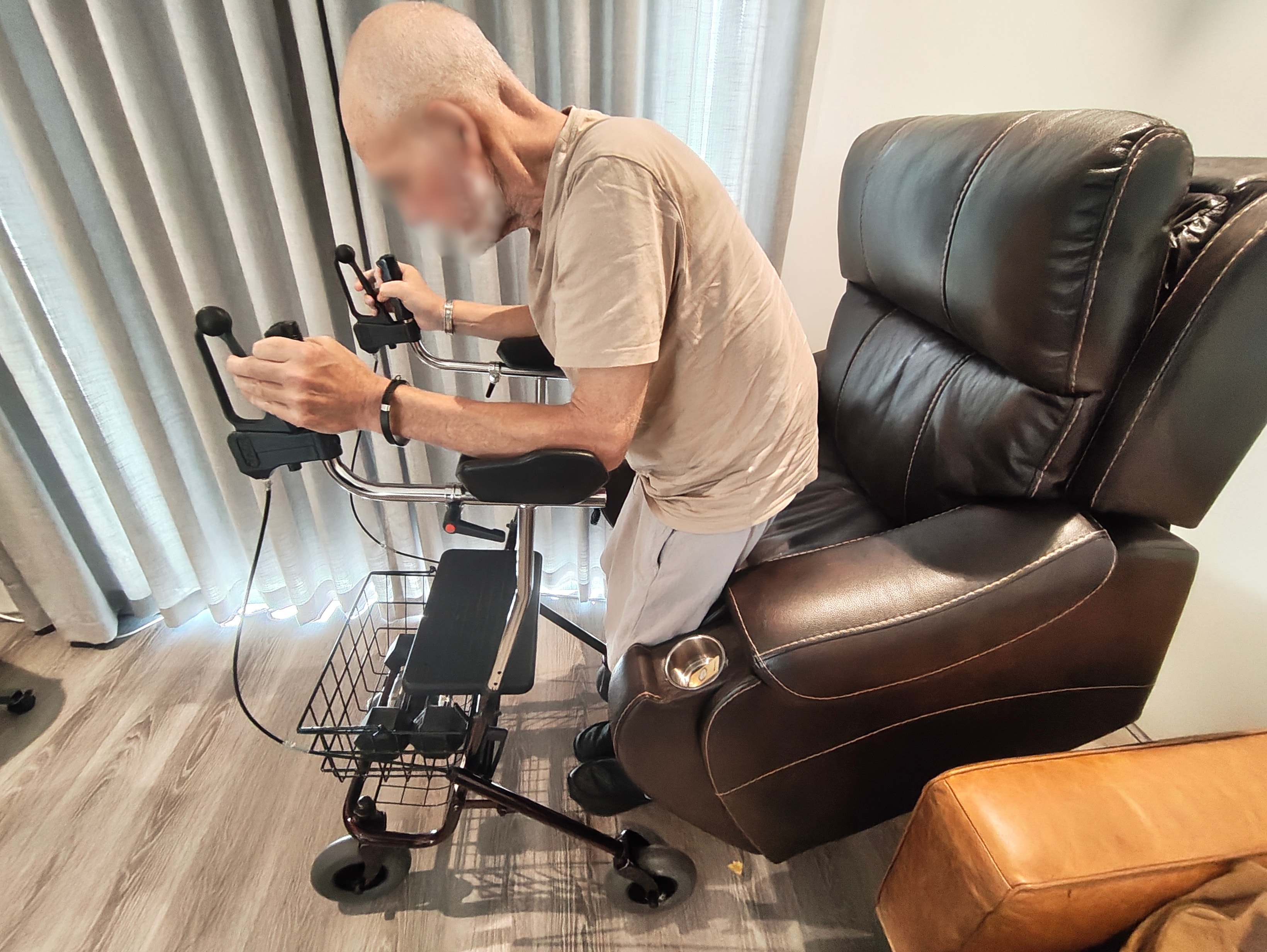 Physiotherapist assisting a patient with standing and mobility using a walking frame at home